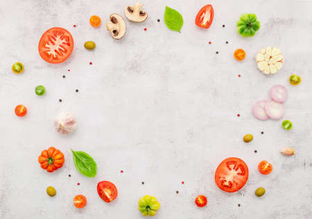The ingredients for homemade pizza set up on white concrete background.の写真素材