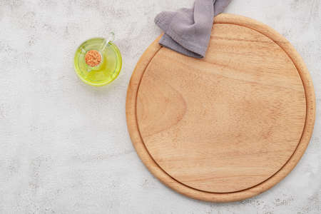 Empty wooden pizza platter set up on white concrete. Pizza board on white concrete background flat lay and copy space.の写真素材