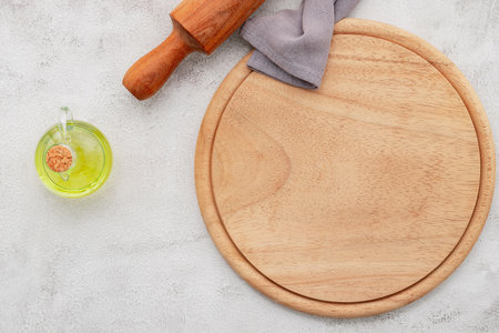 Empty wooden pizza platter set up on white concrete. Pizza board on white concrete background flat lay and copy space.の写真素材