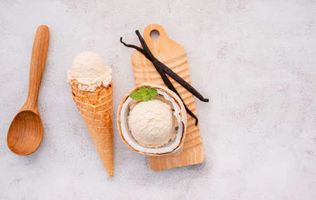 Coconut ice cream flavours in half of coconut setup on white stone background. Summer and Sweet menu concept.の写真素材