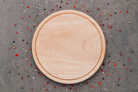Empty pizza platte with spices set up on dark concrete background flat lay and copy space.の写真素材