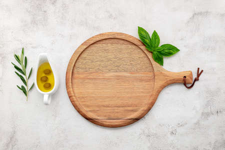 Empty wooden pizza platter set up on white concrete. Pizza tray on white concrete background flat lay and copy space.の写真素材