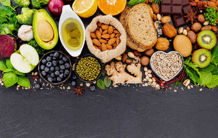 Ingredients for the healthy foods selection. The concept of healthy food set up on dark stone background.の写真素材