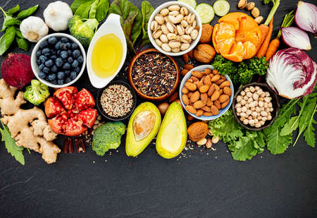Ingredients for the healthy foods selection. The concept of healthy food set up on dark stone background.の写真素材