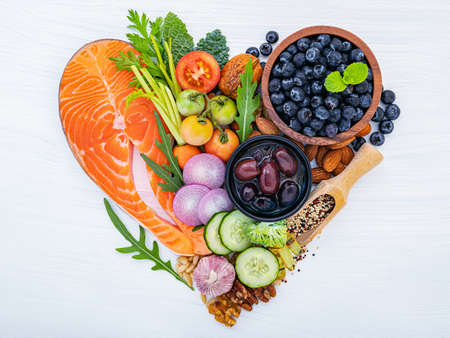 Heart shape of ketogenic low carbs diet concept. Ingredients for healthy foods selection on white wooden background.の写真素材