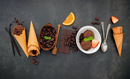 Chocolate ice cream flavours in bowl with dark chocolate and cacao nibs setup on dark stone background .の写真素材