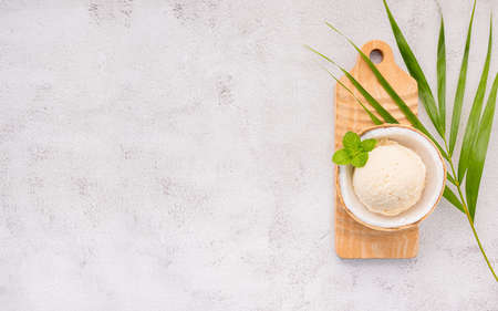 Coconut ice cream flavours in half of coconut setup on white stone background. Summer and Sweet menu concept.の写真素材