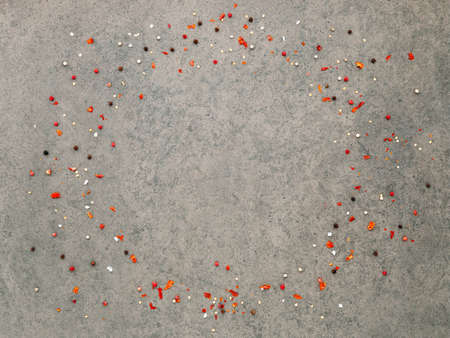 Top view of dark concrete background with peppercorn and chilli flakes.の写真素材
