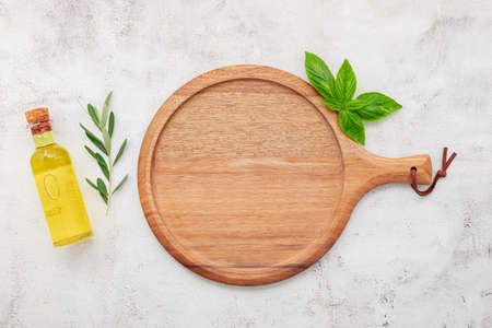 Empty wooden pizza platter set up on white concrete. Pizza tray on white concrete background flat lay and copy space.の写真素材