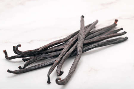 Dried vanilla sticks set up on marble background.の写真素材