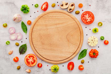 The ingredients for homemade pizza set up on white concrete background.の写真素材