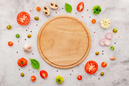 The ingredients for homemade pizza set up on white concrete background.の写真素材
