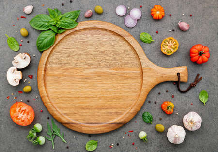 The ingredients for homemade pizza set up on dark stone background.の写真素材