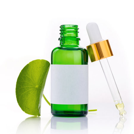 Close up centella asiatica extract in green bottles with centella asiatica leaves isolated on white background.の写真素材