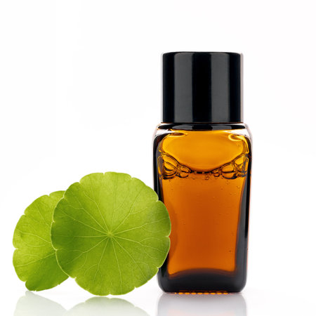 Close up centella asiatica extract in amber bottle with centella asiatica leaves isolated on white background.の写真素材