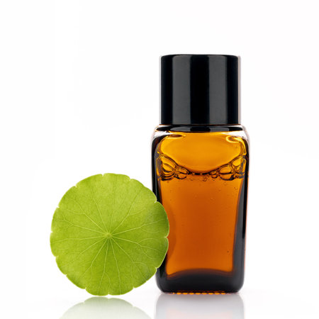 Close up centella asiatica extract in amber bottle with centella asiatica leaves isolated on white background.の写真素材