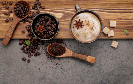 Roasted coffee beans with coffee cup setup on dark stone background.の写真素材