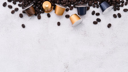 Dark roasted coffee beans setup on white concrete background with copy space.の写真素材