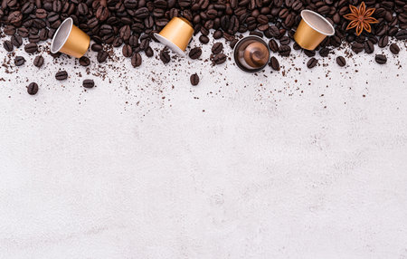 Dark roasted coffee beans setup on white concrete background with copy space.の写真素材
