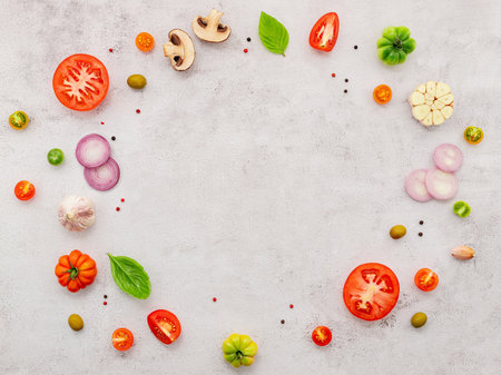 The ingredients for homemade pizza set up on white concrete background.の写真素材