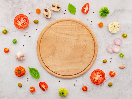 The ingredients for homemade pizza set up on white concrete background.の写真素材