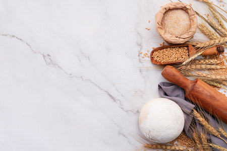 Wheat ears and wheat grains set up on marble background. Top view and copy spaceの写真素材
