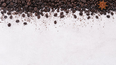 Dark roasted coffee beans setup on white concrete background with copy space.の写真素材