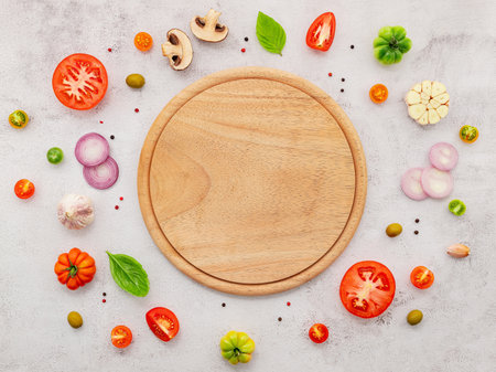 The ingredients for homemade pizza set up on white concrete background.の写真素材