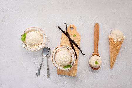 Coconut ice cream flavours in half of coconut setup on white stone background. Summer and Sweet menu concept.の写真素材