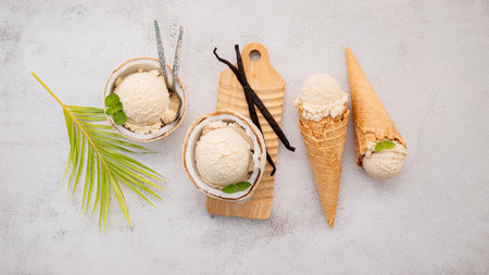 Coconut ice cream flavours in half of coconut setup on white stone background. Summer and Sweet menu concept.の写真素材