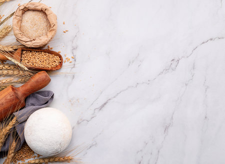 Wheat ears and wheat grains set up on marble background. Top view and copy spaceの写真素材