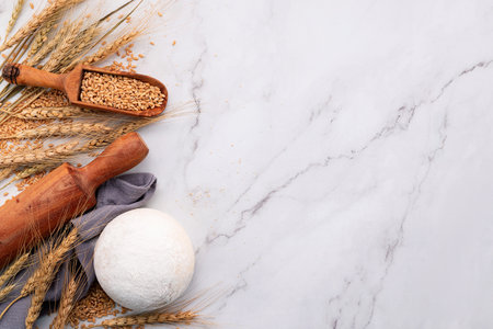 Wheat ears and wheat grains set up on marble background. Top view and copy spaceの写真素材