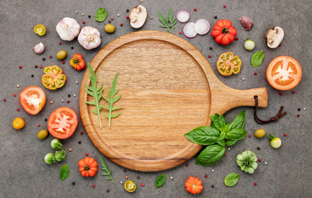 The ingredients for homemade pizza set up on dark stone background.の写真素材