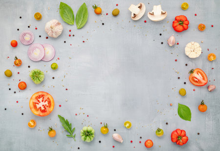 The ingredients for homemade pizza with wooden pizza tray set up on grey concrete background. top viewの写真素材