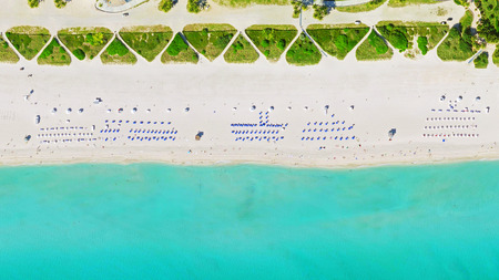 aerial bird's eye view of surfer in tropical clear water miami beachの写真素材