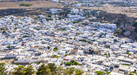 Cityscape of Lindos ancient city with whitewashed little houses densely located each other and narrow streets on Rhodes islandの写真素材