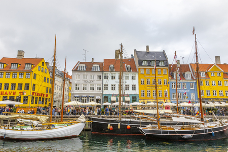 Copenhagen, Denmark - October 6, 2018: Copenhagen in the fall nyhavn is especially popular place in Copenhagen a lot of tourists walking around the canal, taking selfies sitting in restaurantのeditorial素材