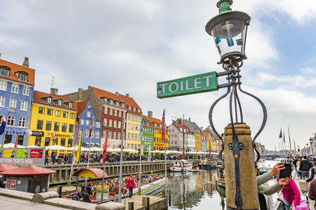 Copenhagen, Denmark - October 6, 2018: Copenhagen in the fall nyhavn is especially popular place in Copenhagen a lot of tourists walking around the canal, taking selfies sitting in restaurantのeditorial素材