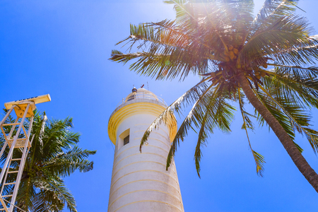 Lighthouse in Galle fort historic lighthouse at a fort with simple style and a nearby beach popular with swimmers, Galle, Sri Lankaの写真素材