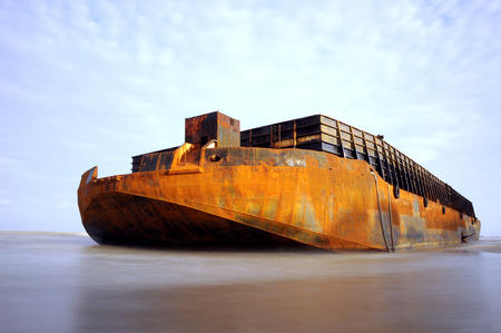 a huge barge stranded at the beachの写真素材