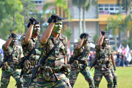 KUANTAN, MALAYSIA - AUG 31: Royal Malaysia Army demonstrate a hand combat defending at the National Day parade, celebrating the 55th anniversary of independence on August 31, 2012 in Kuantan, Pahang, Malaysia.のeditorial素材
