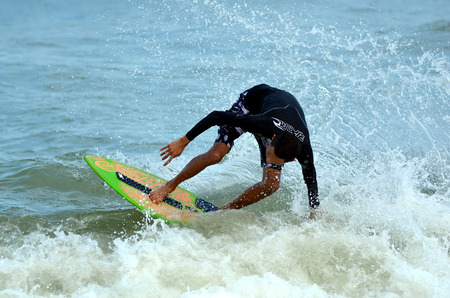 KUANTAN - DECEMBER 29: unidentified surfer in action catching waves in evening at Teluk Cempedak...