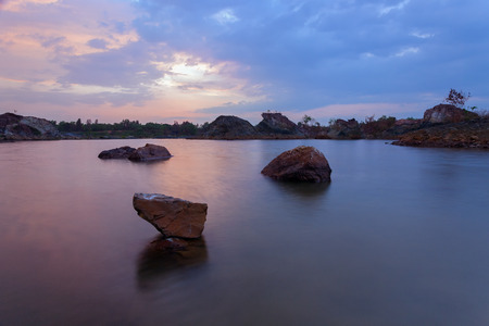 The stepping stone. This is a abandon quarry and the picture was captured during sunset with the stone in the middle of the picture.の写真素材