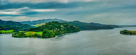 Panoramic view of the mountains and lake on a cloudy day in south Polandの写真素材