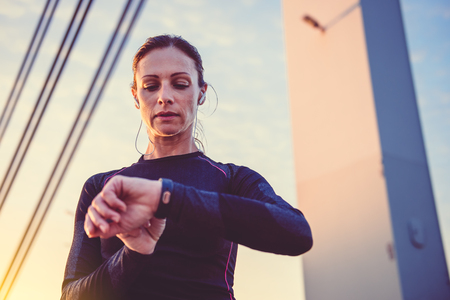 Woman monitoring her progress on smart watchの写真素材