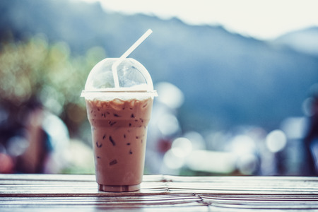 ice coffee on a wood with nature background