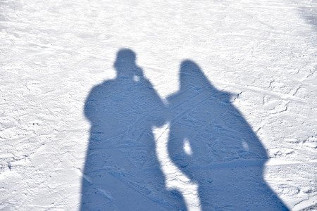 People shadows with reflection on the snowの写真素材
