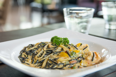black Spaghetti With shrimp in spinach cream Sauceの写真素材
