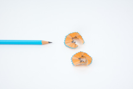 green pencil with cuttings in curve shape isolated on white.の写真素材