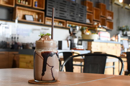 Ice chocolate with whipped cream on tableの写真素材